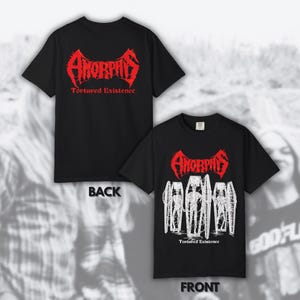May include: Black t-shirts with the band name "Amorphis" in red, stylized font. The front of the shirt features a graphic of coffins and the text "Tortured Existence". The back of the shirt displays the band name and the text "Tortured Existence".