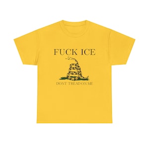May include: Mustard yellow t-shirt featuring the text "FUCK ICE" above a coiled snake graphic. Below the snake, the text reads "DON'T TREAD ON ME". The graphic is black and green.