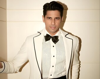May include: A formal ensemble featuring a white blazer with black trim, a striped shirt, and a black bow tie. The outfit includes a black waist detail and black trousers, creating a classic, elegant look.