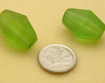 May include: Two faceted lime green beads with a translucent finish, each featuring a central hole. A Canadian 25-cent coin is positioned between the beads to provide a clear sense of scale for the size of these two individual craft components.