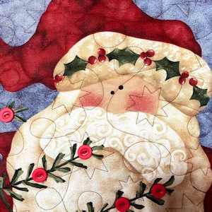 Exquisitely quilted vintage advent calendar featuring Santa Claus holding a Christmas Tree. Twenty-four buttons have been securely stitched to hang the cotton and felt ornaments day each day leading up to Christmas. Nancy Halverson holiday panel.