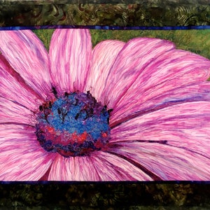 May include: A close-up of a pink flower with a blue and purple centre. The flower has a delicate, almost translucent appearance.