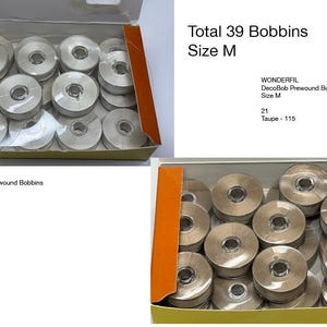 May include: A collection of 39 Wonderfil DecoBob prewound bobbins in size M, presented in two open cardboard boxes. One box contains 21 taupe-colored bobbins, and the other contains 18 grey-colored bobbins, each featuring a clear plastic center core.