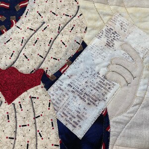 May include: A vintage quilt with a woman's figure in a red and white dress. The quilt is made of various fabrics and includes a piece of paper with French text. The text reads: "De l'Eaudatior stoute que des accords du Greveile aires du personnel exceptionrs venait d'e couveli-nt, a co-alocisat rematrice de L'&eacute;cole du c&ocirc;t&eacute; d ne balayease Men vare itenst".
