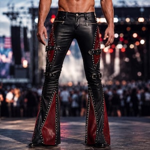 May include: Black leather pants featuring a flared leg design with deep red side panels. The pants include silver-toned metal studs along the seams, horizontal buckled straps across the thighs, and zippered pockets at the waistline.