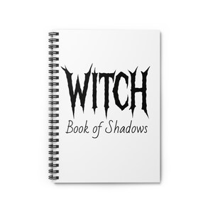 May include: A white spiral-bound notebook with the words "WITCH Book of Shadows" printed in black. The word "WITCH" is in a gothic font. The notebook is blank and ready for spells and notes.