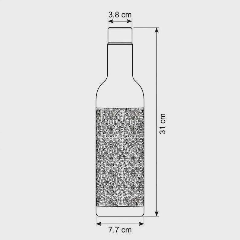 Close-up view of the intricate engraved copper detailing on a black copper water bottle. The decorative pattern creates a beautiful antique finish against the matte black surface. This traditional Indian inspired design combines vintage character with Boho Luxe styling and makes the 1000ml reusable bottle a distinctive everyday hydration accessory.