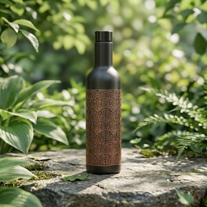 Unique engraved copper water bottle in black and antique copper, featuring an intricate vintage-inspired pattern and approximately one-liter capacity. This stylish reusable bottle makes a thoughtful gift for yoga enthusiasts, wellness lovers, fans of traditional Indian craftsmanship, and anyone who appreciates distinctive Boho Luxe accessories and decorative drinkware.