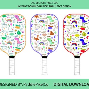 May include: Three pickleball paddles with colorful designs. Each paddle features a white background with a different border color: yellow, purple, and red. The designs include unicorns, dinosaurs, rainbows, and text that says "love me", "hello", "magic", and "be wild".