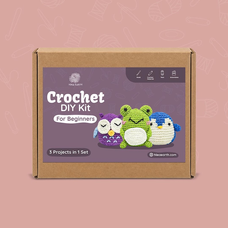May include: A brown cardboard box featuring a Crochet DIY Kit for Beginners. The kit includes three crochet projects: an owl, a frog, and a penguin. The kit's label includes the text "3 Projects in 1 Set" and the website "Nioearth.com".