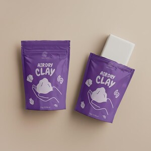 May include: Two purple pouches of air dry clay, each with the words "Air Dry Clay" and a graphic of hands holding a cloud-like shape. One pouch has a white block partially visible. Each pouch contains 1 kg of clay.