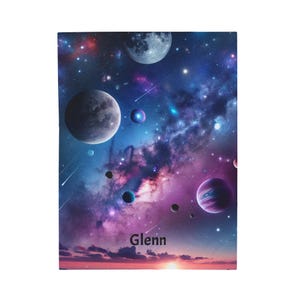 May include: A notebook featuring a vibrant space-themed design. The cover showcases a colorful galaxy with planets, stars, and a nebula. The name "Glenn" is printed in white at the bottom. The overall color scheme includes blues, purples, and pinks.