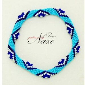 May include: A blue, white, and dark blue beaded bracelet with a chevron pattern. The bracelet is made of small beads and is about 7 inches in length.