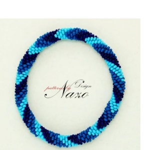 May include: A blue and turquoise beaded bracelet with a spiral pattern. The bracelet is made of small, round beads and has a simple, elegant design.