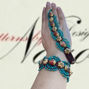 Könnte beinhalten: Ein türkisfarbenes und rotes Perlenarmband mit goldenen Akzenten. Das Armband besteht aus kleinen Perlen und hat einen Quastenanhänger.