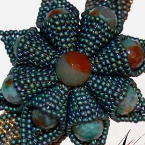 May include: A beaded flower pendant featuring a green, blue and brown colour scheme. The flower is crafted from small beads and has a large, round, green, brown and red agate stone at its centre.