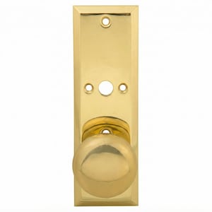 May include: A polished brass door knob set featuring a rectangular backplate with beveled edges. The assembly includes a spherical knob and a flat mounting plate with three pre-drilled screw holes and a central opening for the door mechanism.