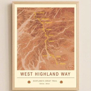 May include: A framed print of the West Highland Way, a hiking trail in Scotland. The map shows the trail's route with yellow lines and place names. The print is in a light wood frame and includes the text "WEST HIGHLAND WAY" and "SCOTLAND'S GREAT TRAIL, 154 km / 96 mi."