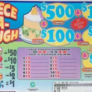 May include: A rectangular Piece-A-Dough lottery game ticket featuring a cake illustration, prize amounts of $500, $125, $100, $75, $50, $25, $10, $5, $2, and $1, and a list of winning numbers from 013 to 1113 printed on a light green and blue background.