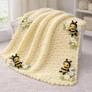 May include: A light yellow crocheted baby blanket with a scalloped edge. The blanket is decorated with three-dimensional bees and white and yellow flowers. The blanket is folded over a white basket.