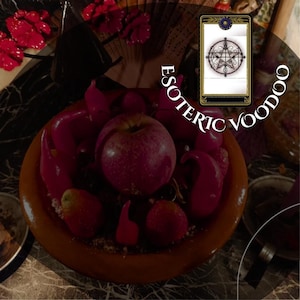 May include: A still life arrangement featuring a terracotta bowl filled with red apples, strawberries, and chili peppers. The image is overlaid with the text "ESOTERIC VOODOO" and a tarot card.