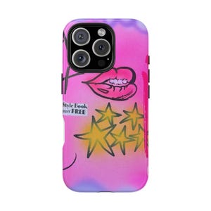 May include: A phone case with a vibrant pink and purple background. The case features a drawing of a mouth, yellow stars, and the text "Style Book Yours FREE". The case has a black camera module.