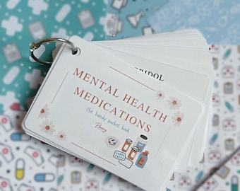 May include: A white flashcard set bound by a silver metal ring. The front card features the text MENTAL HEALTH MEDICATIONS, The handy pocket book, and Penny, decorated with small floral accents and illustrations of various pill bottles and tablets.
