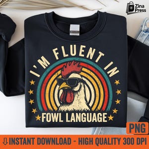 May include: Black sweatshirt with a retro design featuring a rooster wearing sunglasses and the text "I'm Fluent in Fowl Language." The design includes a rainbow and stars. The image also includes the text "Instant Download - High Quality 300 DPI."