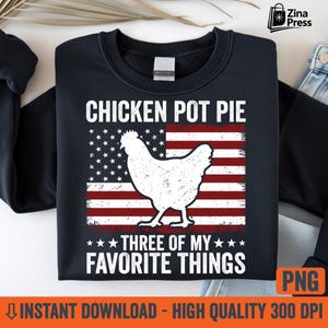 May include: A navy blue sweatshirt with a distressed white graphic of a chicken over an American flag design. The text reads "CHICKEN POT PIE THREE OF MY FAVORITE THINGS".