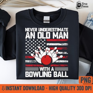 May include: Black sweatshirt with a bowling-themed graphic. The design includes a bowling ball, pins, and an American flag motif. Text reads "NEVER UNDERESTIMATE AN OLD MAN WITH A BOWLING BALL." The design is in white and red.