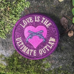 Love is the Ultimate Outlaw handmade iron-on patch.  Still Life with Woodpecker. Tom Robbins inspired