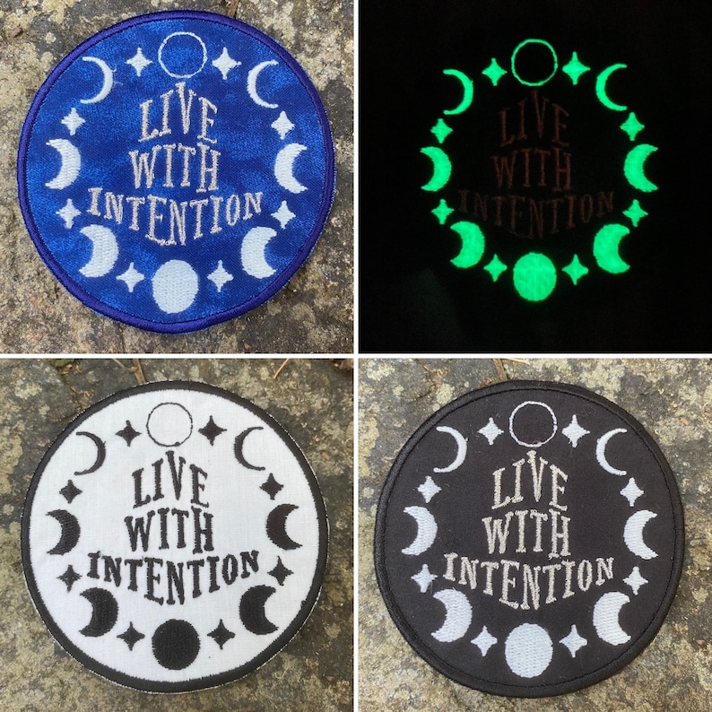 May include: Circular embroidered patches featuring the text "LIVE WITH INTENTION" encircled by crescent moons and stars. The patches are shown in blue, glow-in-the-dark green, white and black.