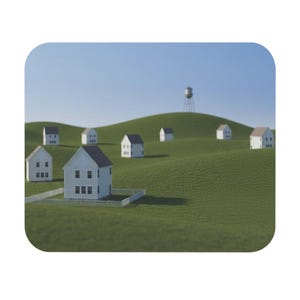 May include: A miniature landscape featuring several small white houses with dark roofs scattered across rolling green hills. A white picket fence surrounds the foreground house, and a tall metal water tower stands on a distant hill under a clear blue sky.