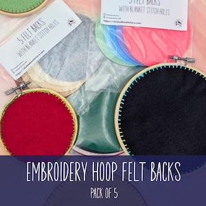 May include: Embroidery hoop felt backs in various colors, including red, black, and green. Each felt back is pre-cut and designed with blanket stitch holes. The image shows a pack of five felt backs, ready for crafting.