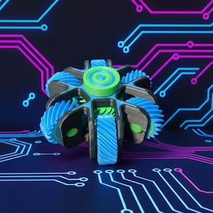 May include: A 3D-printed fidget toy with a complex gear design. The toy features a central green and blue spinner surrounded by blue and black gears. The background is a dark blue with a circuit board design in pink and blue.