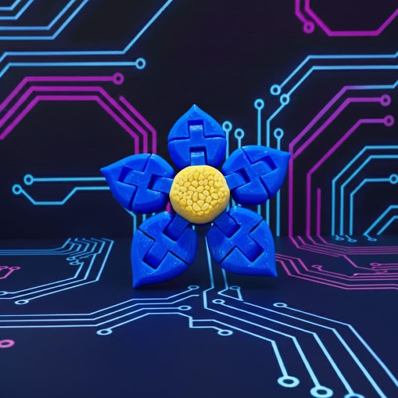 May include: A blue and yellow flower-shaped object with five petals and a textured center. The petals are a vibrant blue, and the center is a textured yellow. The background features a dark blue surface with a circuit board design in blue and purple.