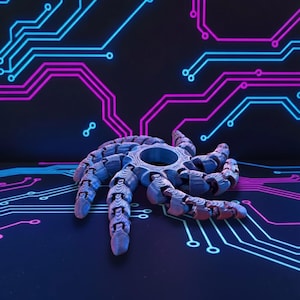 May include: A blue and gray articulated spider toy with a circular center and segmented legs. The toy is set against a dark background with a circuit board design in blue and pink.