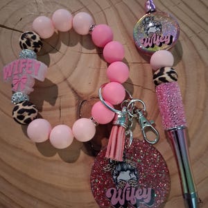 May include: A set of three ceramic mugs with a speckled, matte finish. The mugs are in shades of cream, light gray, and dark gray. Each mug has a simple, minimalist design and a rounded handle.