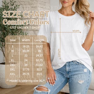 May include: White Comfort Colors 1717 unisex t-shirt with a size chart. The chart shows measurements for sizes S to 4XL, with widths ranging from 18.25 to 29.75 inches and lengths from 26.62 to 33.5 inches. The model is wearing size XL.