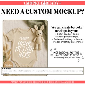 May include: A beige baby bodysuit with the text MOCKED READY YOUR DESIGN HERE, accompanied by a small crocheted rabbit toy. The image includes text advertising custom mockup services for product colours, styles, and themes.