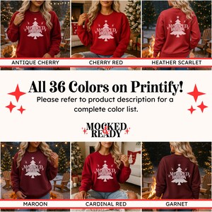 May include: A long-sleeved crewneck sweatshirt in various shades of red, featuring a white graphic of a Christmas tree with a star on top and the text MOCKED READY. The design includes small star accents surrounding the tree graphic.