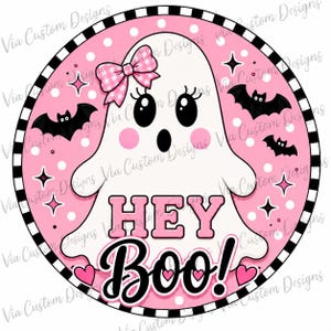 May include: A circular graphic design featuring a white ghost with a pink gingham bow, black eyes, and pink cheeks. The background is pink with white polka dots, black bats, and stars. The text HEY BOO! is centered in pink and black lettering.