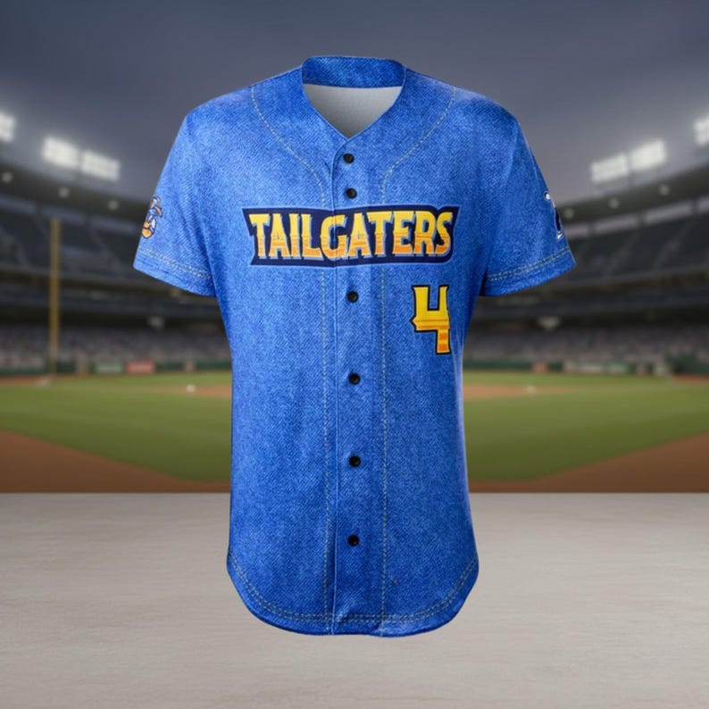 May include: Blue baseball jersey with the word "TAILGATERS" in yellow and black lettering across the chest. The number "4" is also in yellow. The jersey has a denim-like texture and a button-up front.