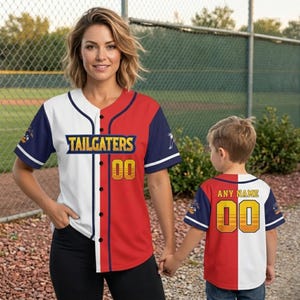 May include: Baseball jerseys with the text "TAILGATERS" and "ANY NAME" in gold. The jerseys are red, white, and navy blue. The adult jersey has the number "00" in gold. The child's jersey also has the number "00" in gold.