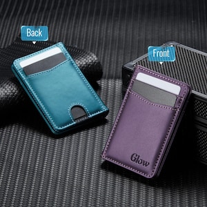 May include: Two slim card wallets, one teal and one purple, are displayed. The teal wallet is labeled "Back" and the purple wallet is labeled "Front". Both wallets have card slots and are made of a smooth material. The purple wallet has the word "Glow" printed on it.