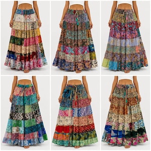 May include: A collection of six floor-length skirts featuring tiered panels of multicoloured fabric with various intricate patterns. Each skirt has an elasticated waistband with a drawstring closure and a full, flowing silhouette.