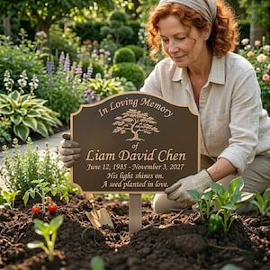 May include: A bronze memorial plaque with the inscription "In Loving Memory of Liam David Chen" and dates. The plaque features a tree design and the words "His light shines on. A seed planted in love." A woman is tending to a garden.