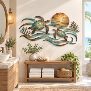 May include: A metal wall art piece featuring two sea turtles swimming through stylized waves with coral accents and a circular sun. The design incorporates shades of teal, blue, and bronze, creating a layered ocean scene with a metallic finish.