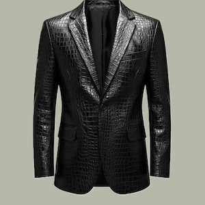 May include: A black blazer with a textured, crocodile-effect pattern. The jacket features a notched lapel, two front pockets, and a single-button closure. This classic blazer is suitable for formal or semi-formal events.