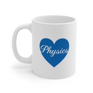 May include: White ceramic mug featuring a blue heart with the word "Physics" in a cursive font. The mug has a curved handle and is suitable for hot or cold drinks. A simple design.